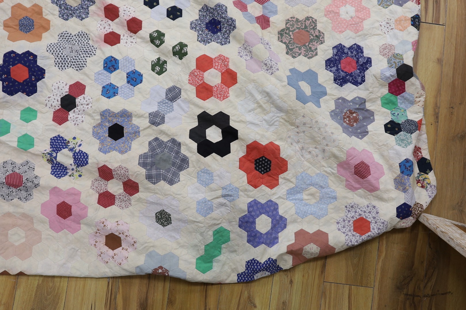 A patchwork quilt, made from Edwardian and later fabrics, 232 cms x 252cms.